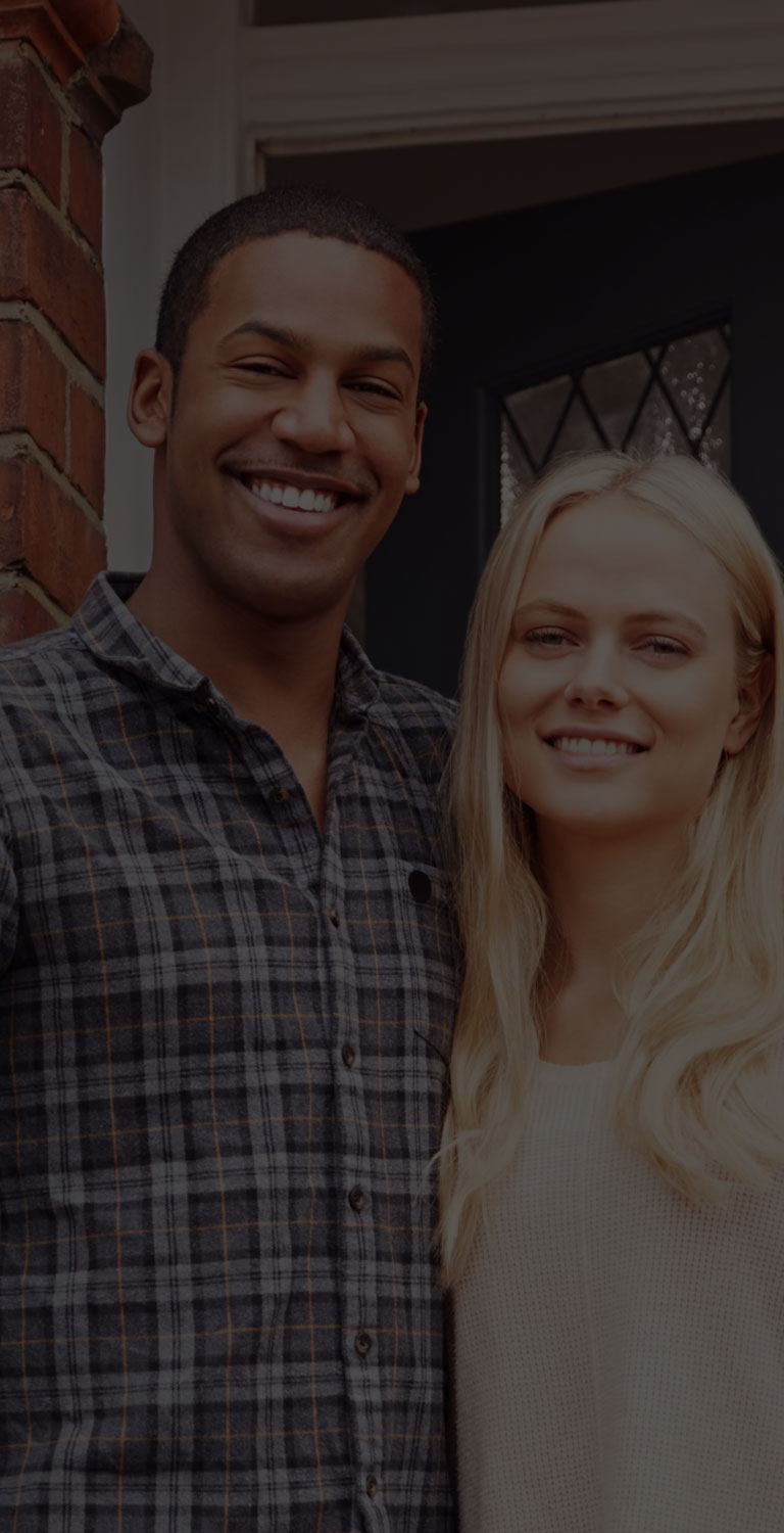 Couple standing outside home mobile