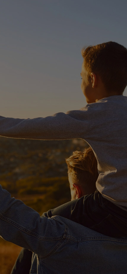 Boy riding on Dad's shoulders