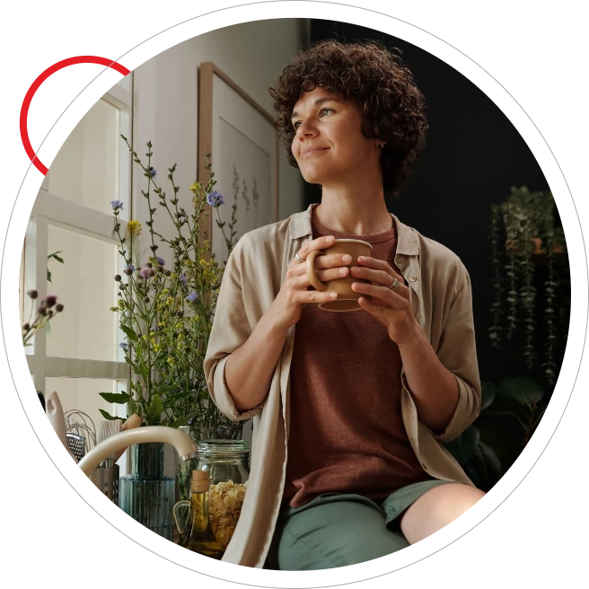 Middle aged woman looking happy and content holding cup of coffee