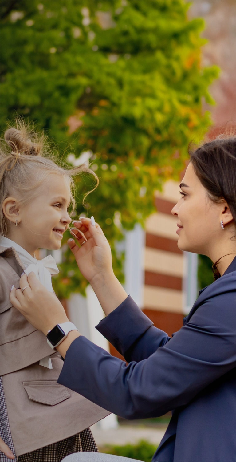 Mother sending daughter off to school mobile