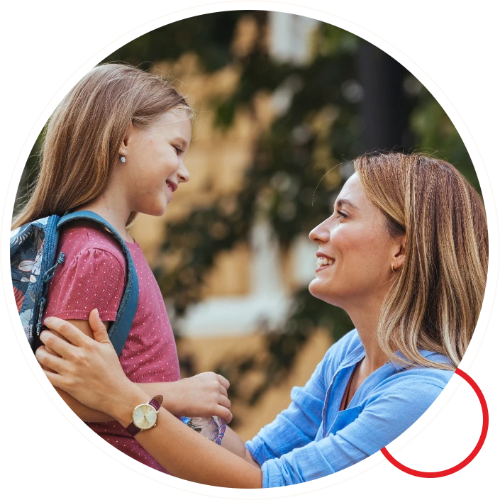 Mother smiling looking at daughter ready for school