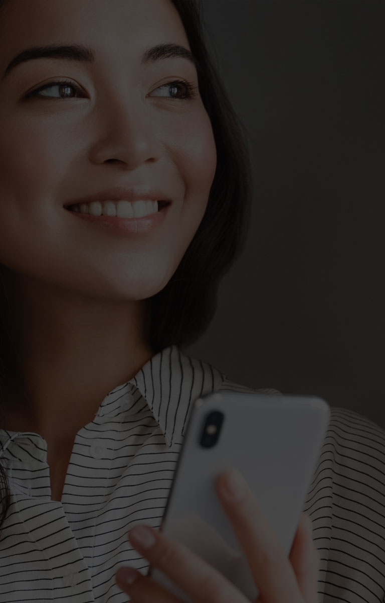 Woman looking hopeful looking outside window mobile