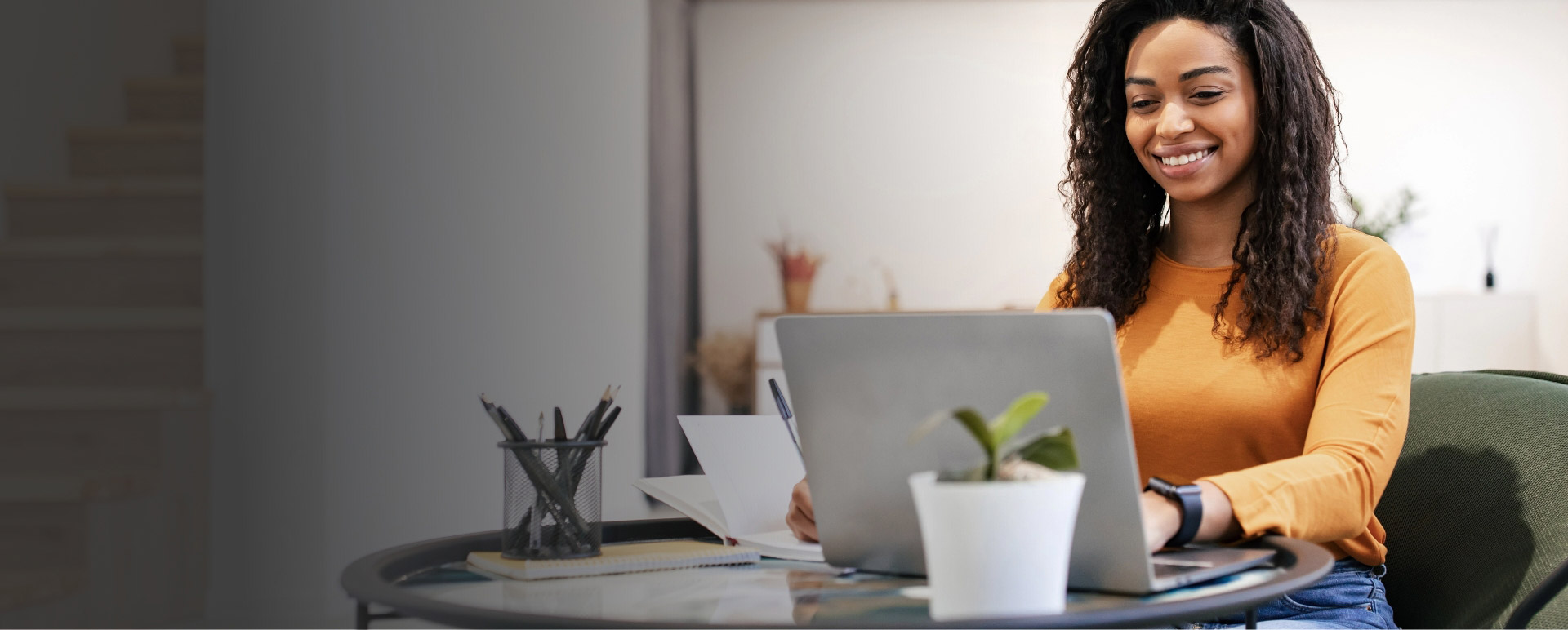 Woman smiling looking at laptop