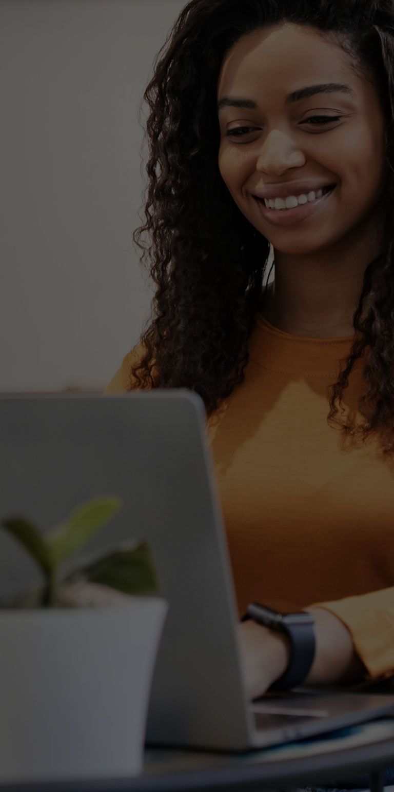Woman smiling looking at laptop mobile