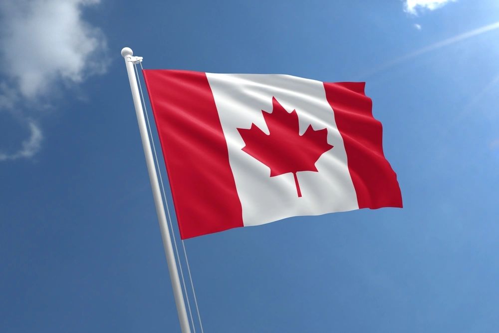 Canada flag on blue sky