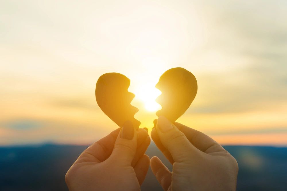 Stone heart in two halves at sunset