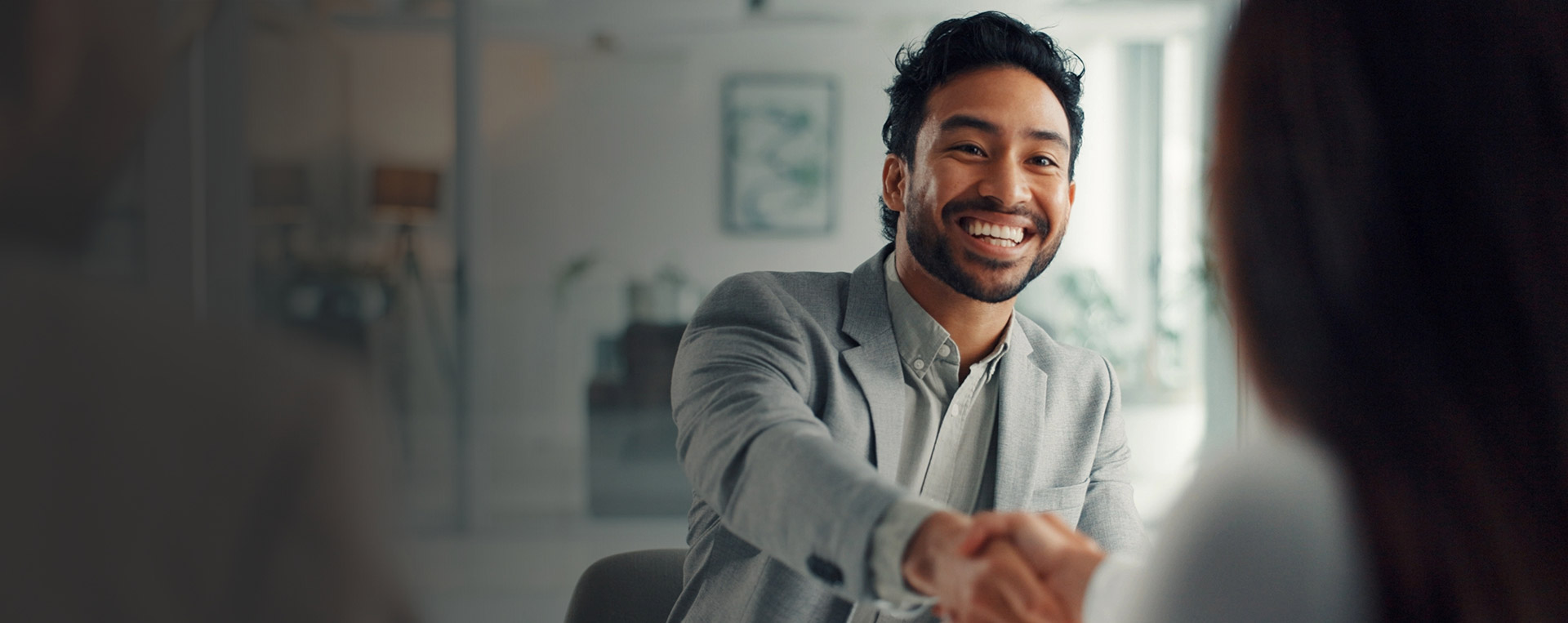 Professional man smiling shaking hands conflict resolved
